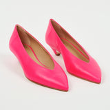 A pair of bright pink leather pointed-toe pumps with kitten heels, displayed on a clean white background.